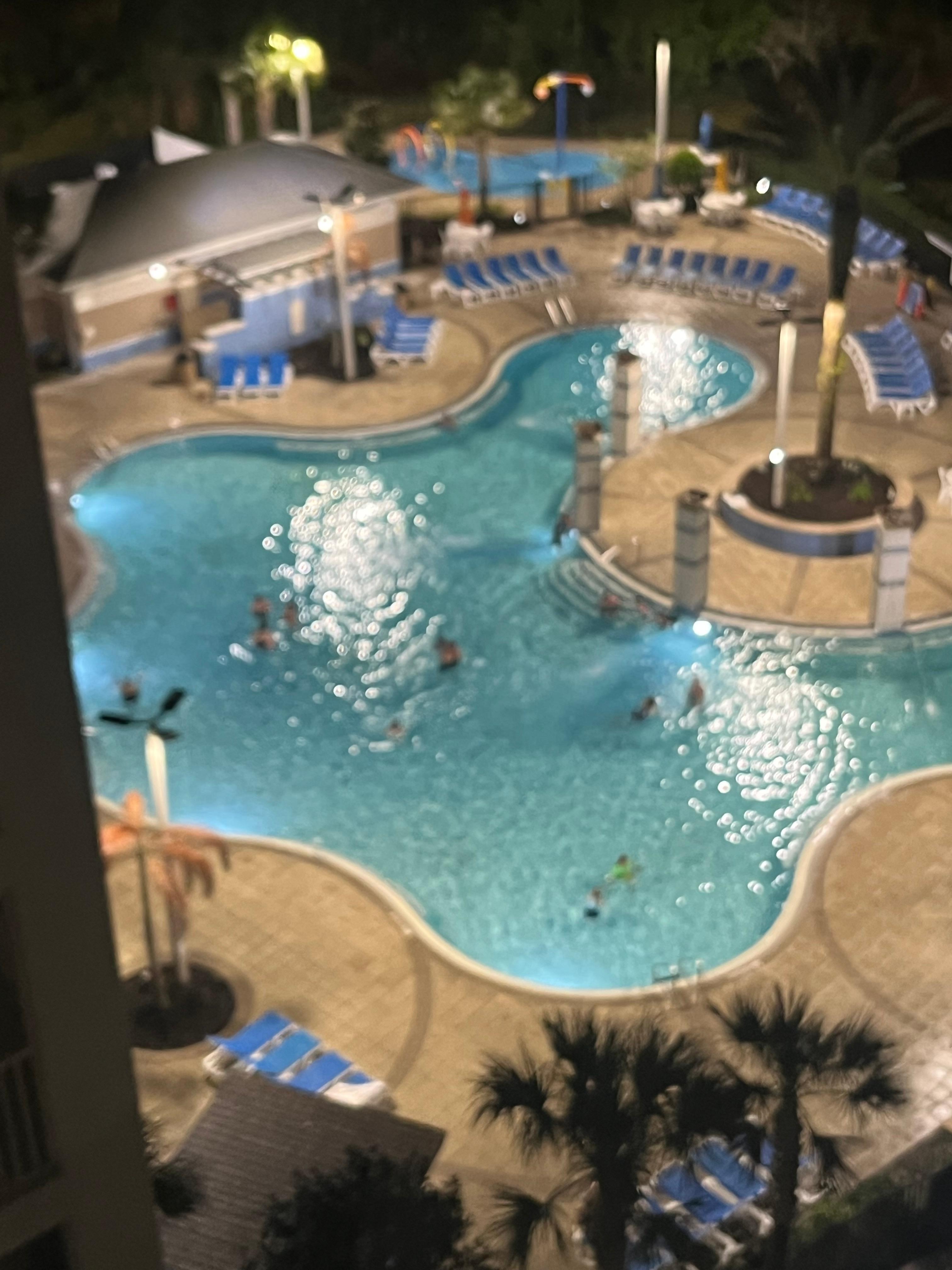 Every building has an abstract shaped pool and hot tub, towel distribution counter and restrooms. Some pools have a deeper end than others. Picnic  area with grills looks clean. 
