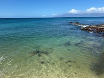 A good view of the sand and rocks in the swimming area