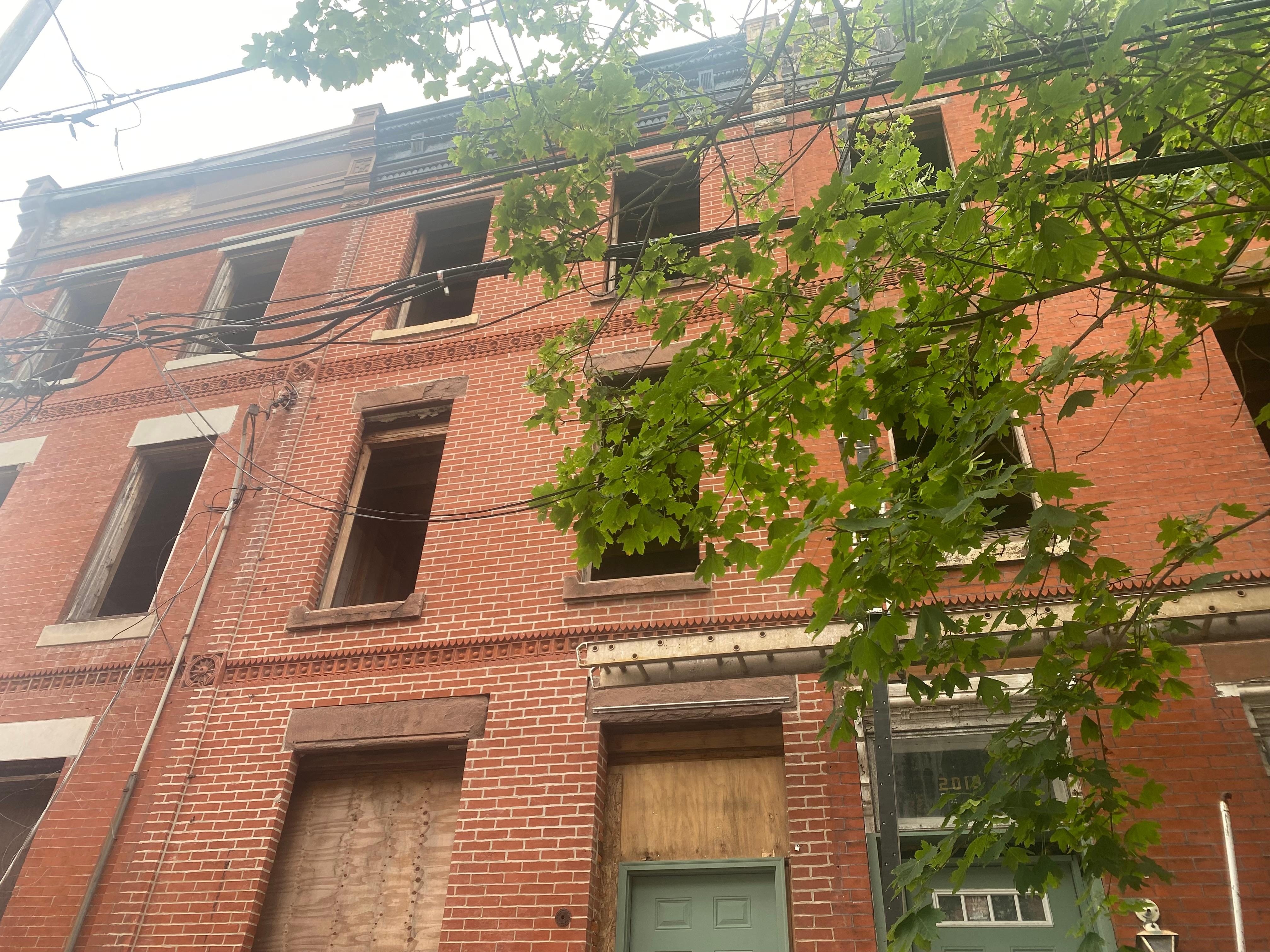 Abandoned building connected on the left, when facing front door. We watched raccoons and rodents exit from behind plywood covering lower windows.