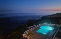 View of pool and beach at night
