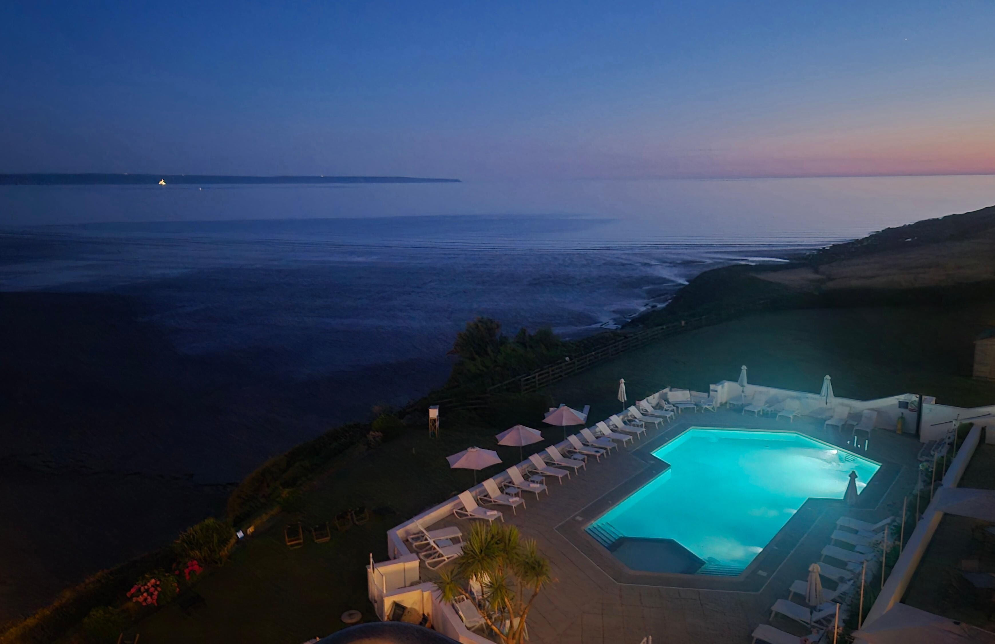 View of pool and beach at night