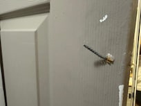 Screw sticking out of bathroom door.