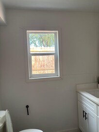 Bathroom window no curtains plain visible from outside