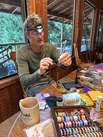 tying flies at cabin