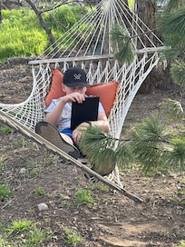 My grandson just loved this hammock n relaxation in the green space n the creekside.