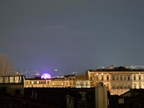 Nighttime view from the same balcony, different direction.