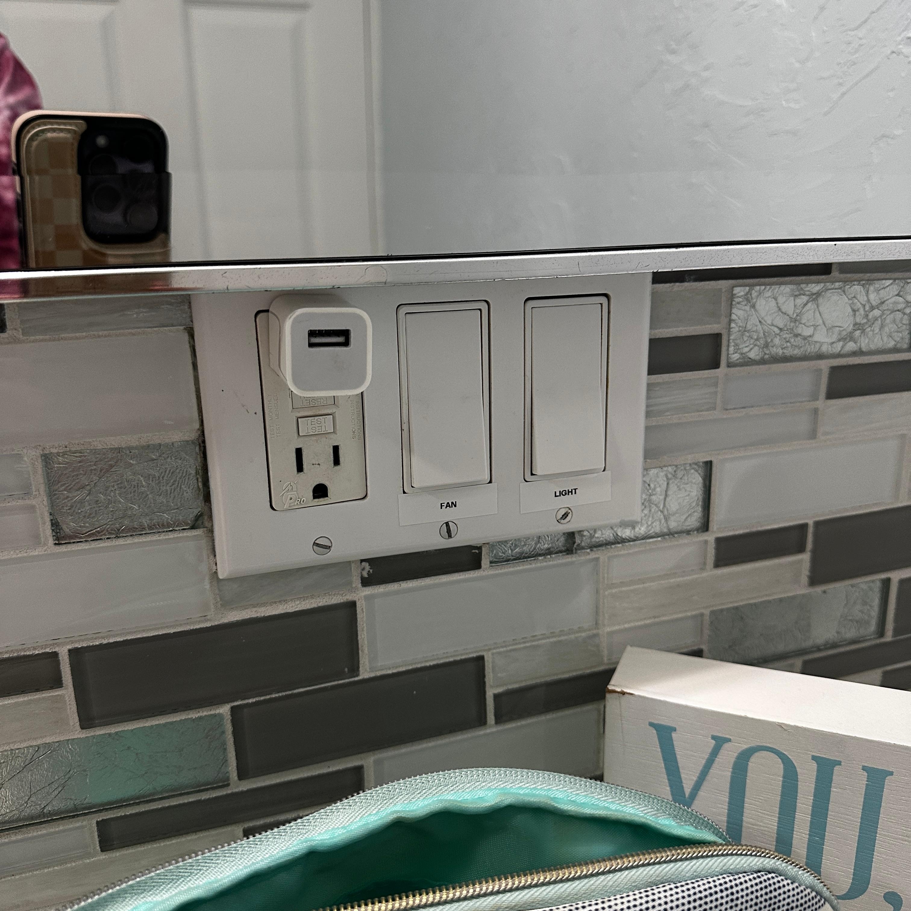 The charger box was glued in the bathroom outlet. Good luck drying your hair and letting your straightener warm up at the same time.
