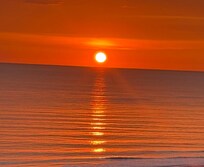 From the balcony you get a total view of the sun setting on the water