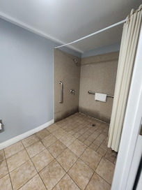 The shower might have been ADA but even then it's not safe because of slipping issues and water clogging while showering