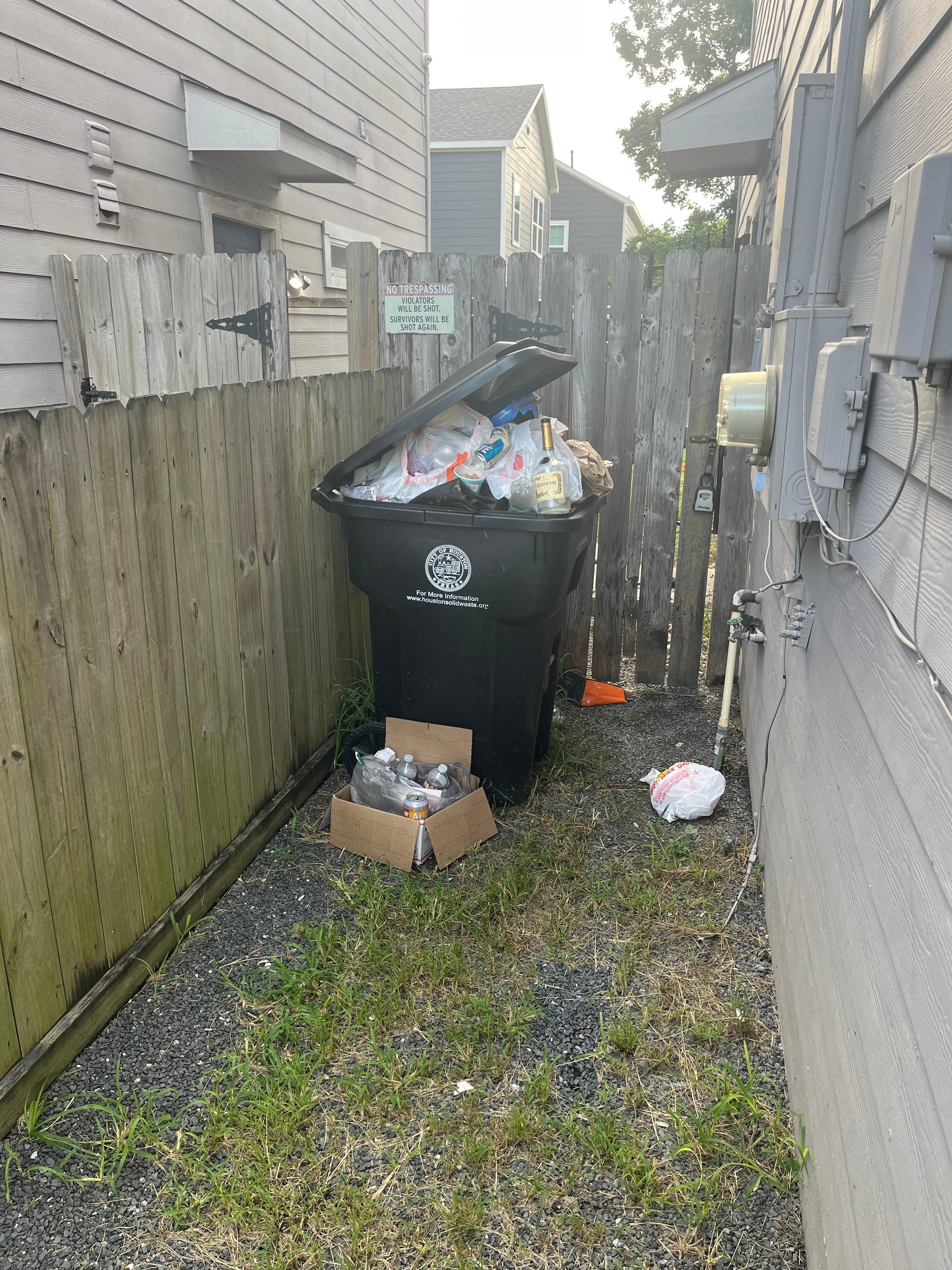 Overloaded Garbage near entrance on space. 