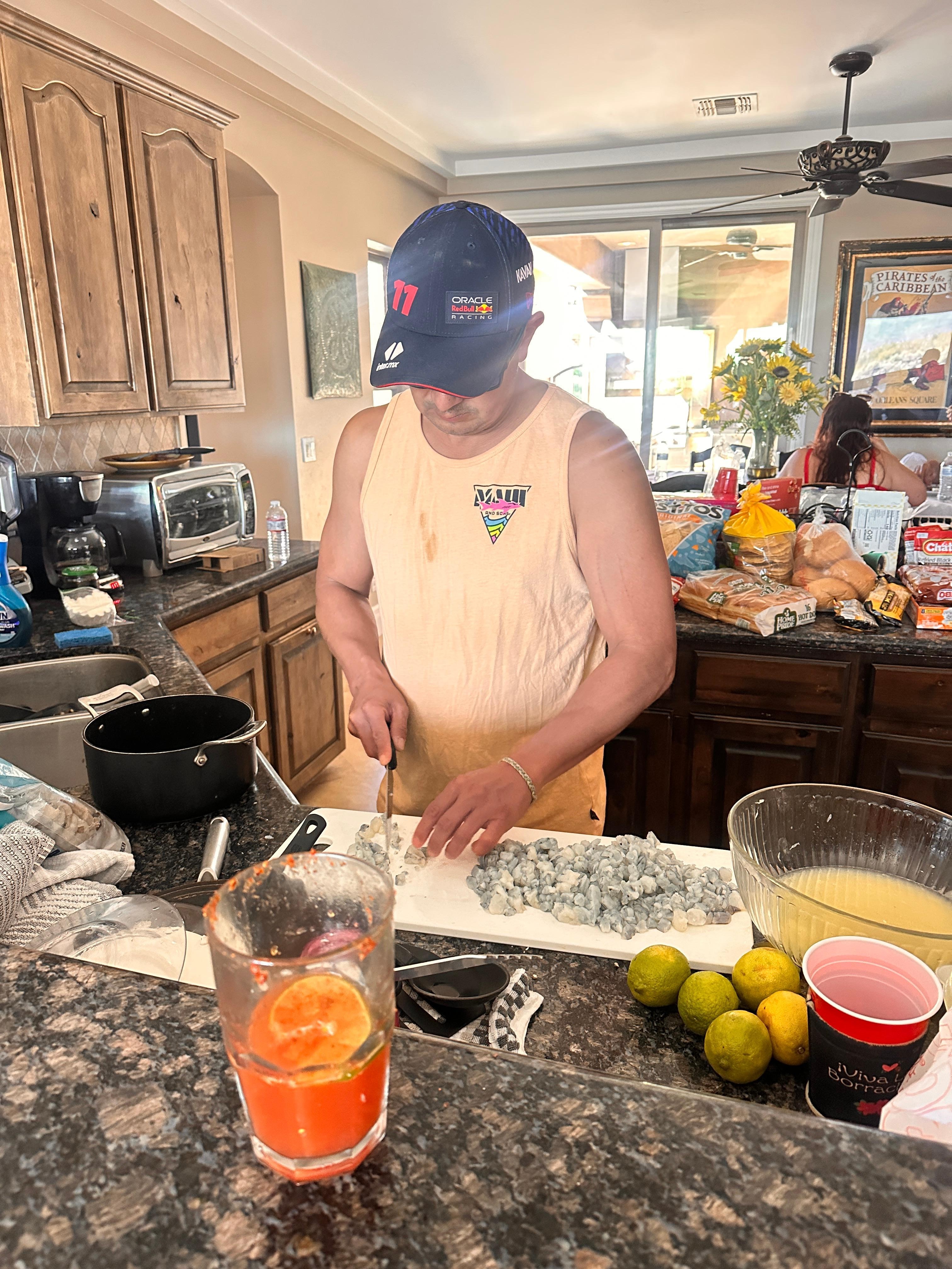 My husband cooking in this fully equipped kitchen. Ceviche by the river is a must with a michelada. 