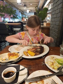 My daughter devouring her steak.