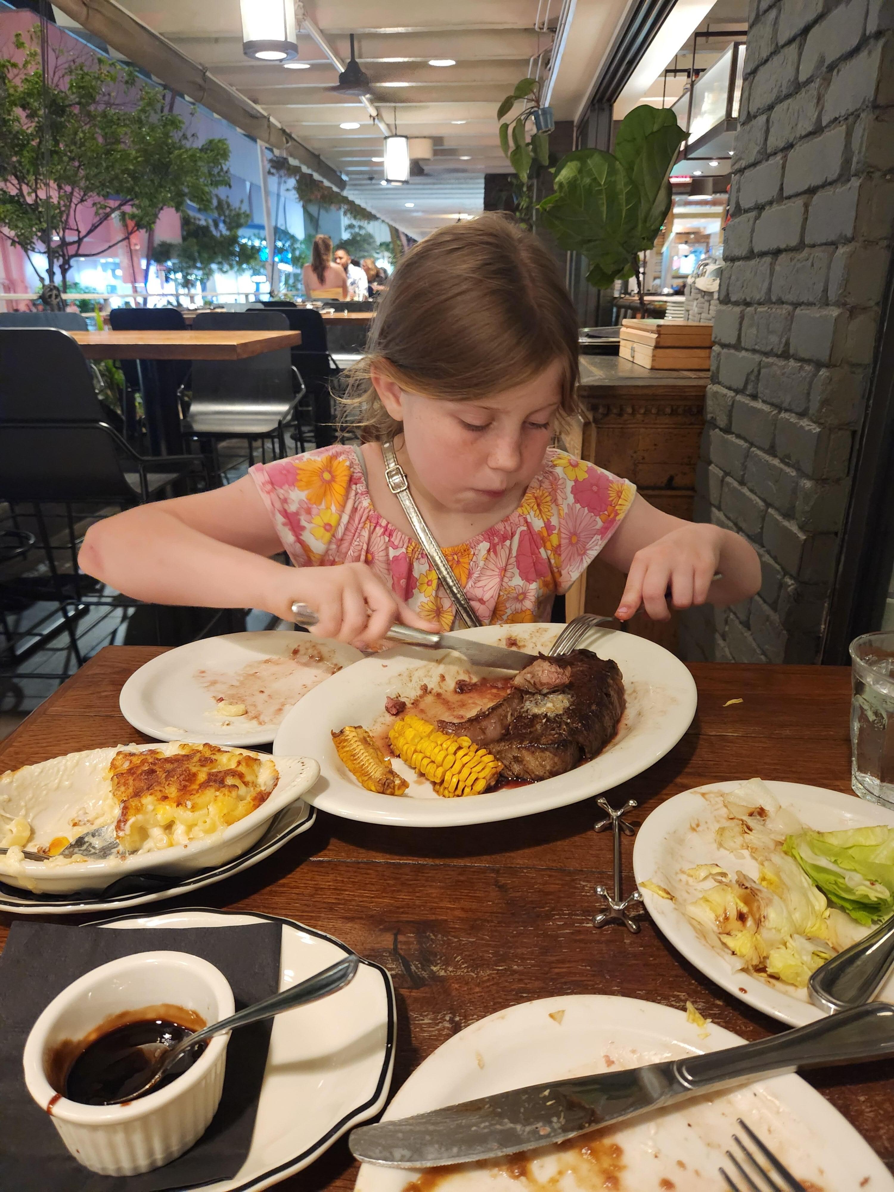 My daughter devouring her steak.