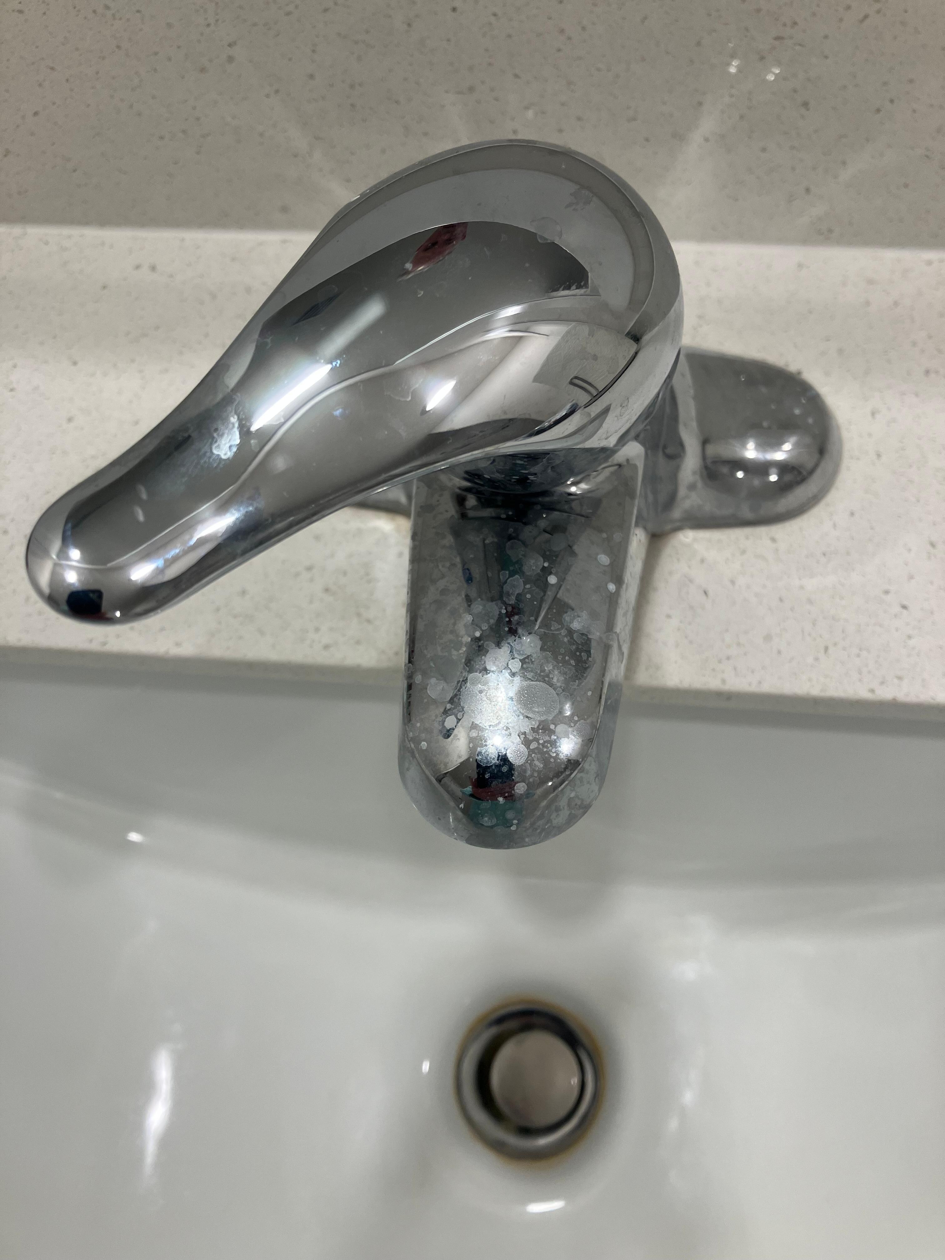 The bathroom sink faucet had not been cleaned.