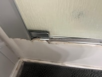 Mold and broken framing around shower door