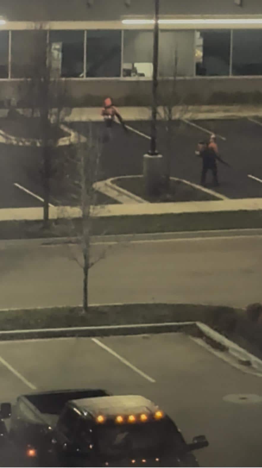 two men with leaf blowers at building across from hotel at 6:45 am on 12/11/2025.