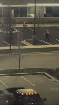 two men with leaf blowers at building across from hotel at 6:45 am on 12/11/2025.