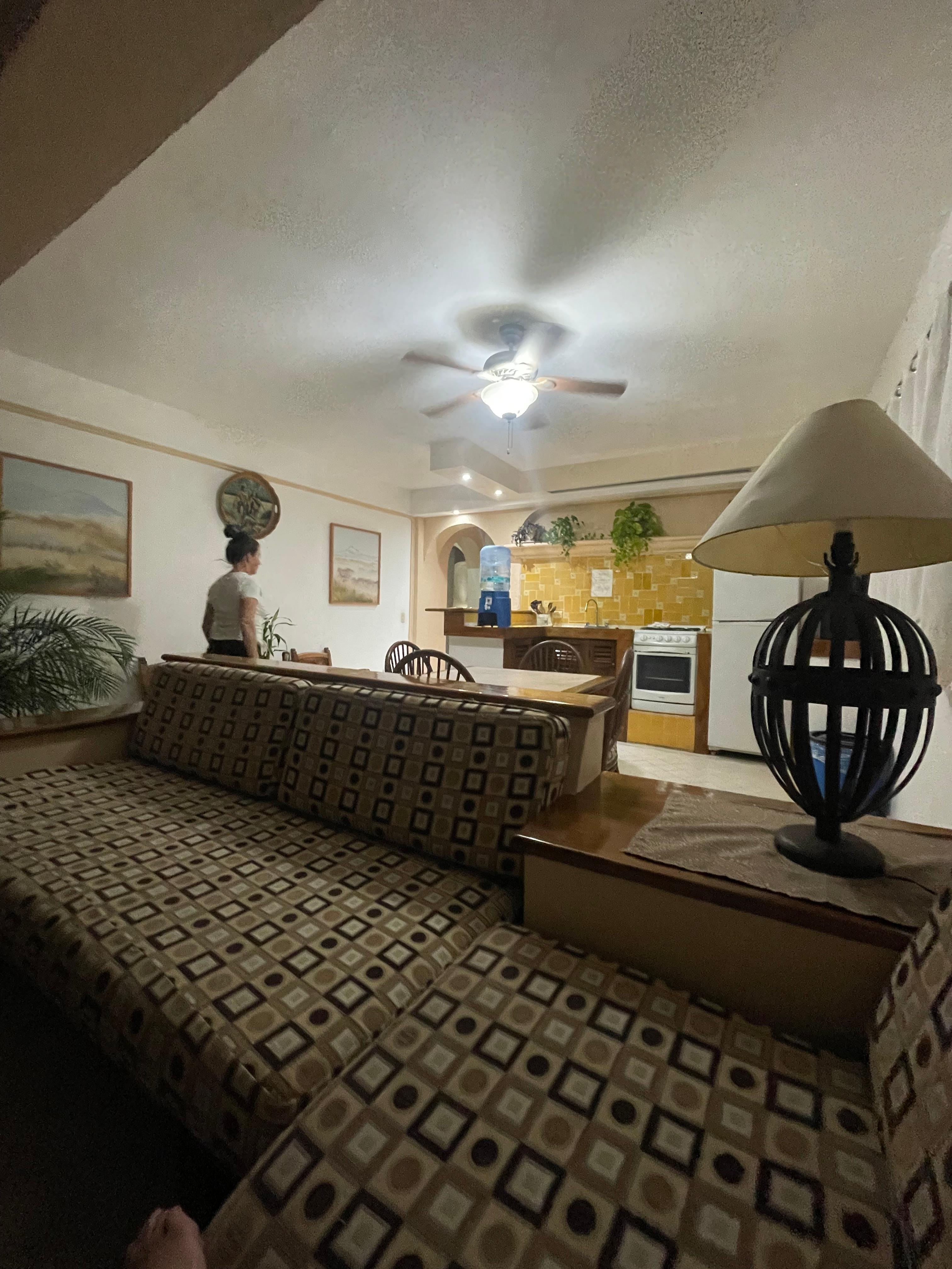 Spacious sitting room looking into kitchen. At night….its very bright with huge windows. Kitchen has all the basics. 