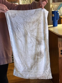 A rag used to clean one of the bathroom sinks and ahowers