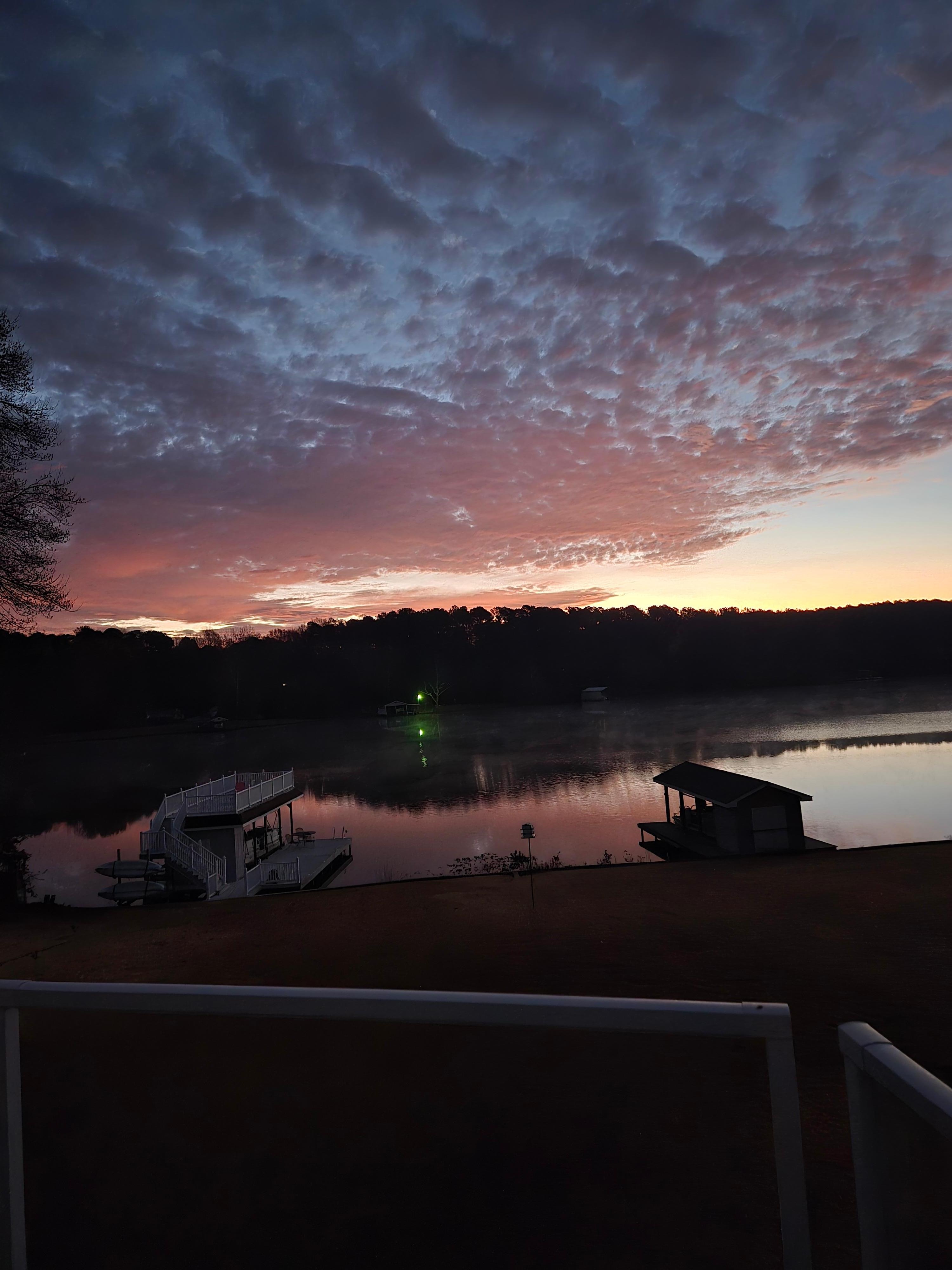 Off rear deck at sunrise, boathouse on left