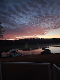 Off rear deck at sunrise, boathouse on left