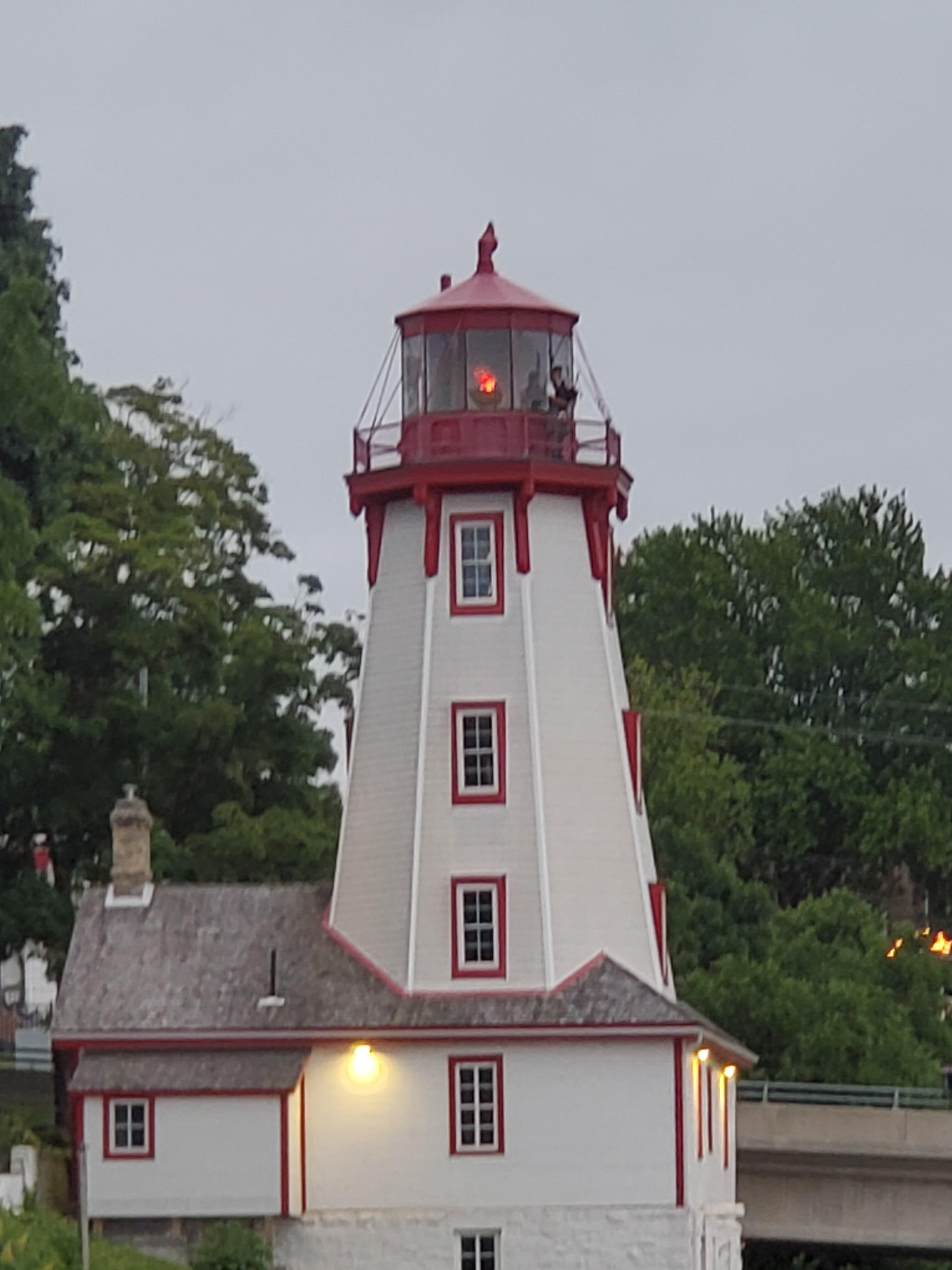 Lone piper playing from top of lighthouse.