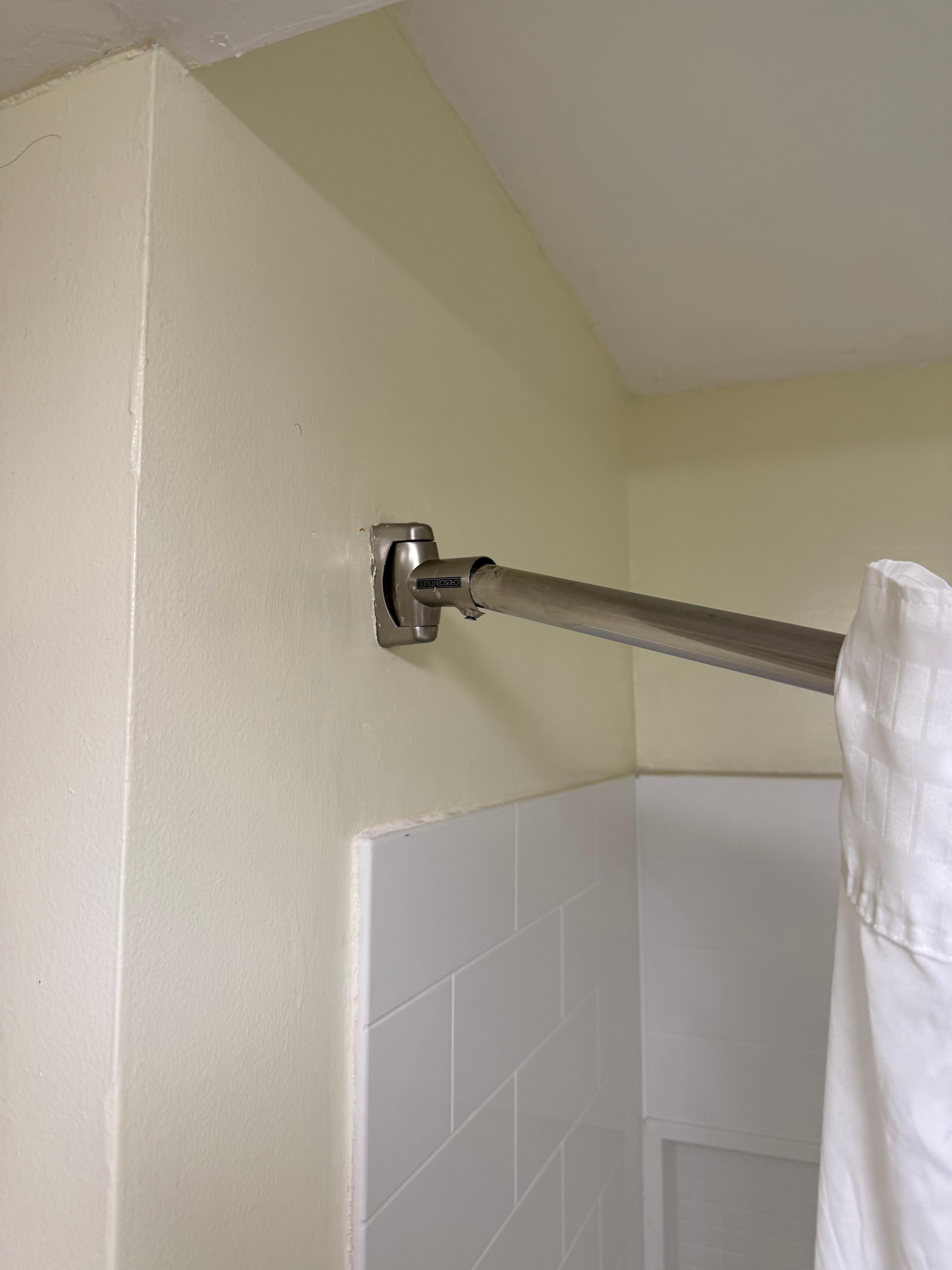 Shower curtain rod mounts loose. Curtain keeps sliding open.