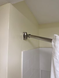 Shower curtain rod mounts loose. Curtain keeps sliding open.