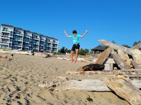 Our grandson on the beach with the condos in the background.