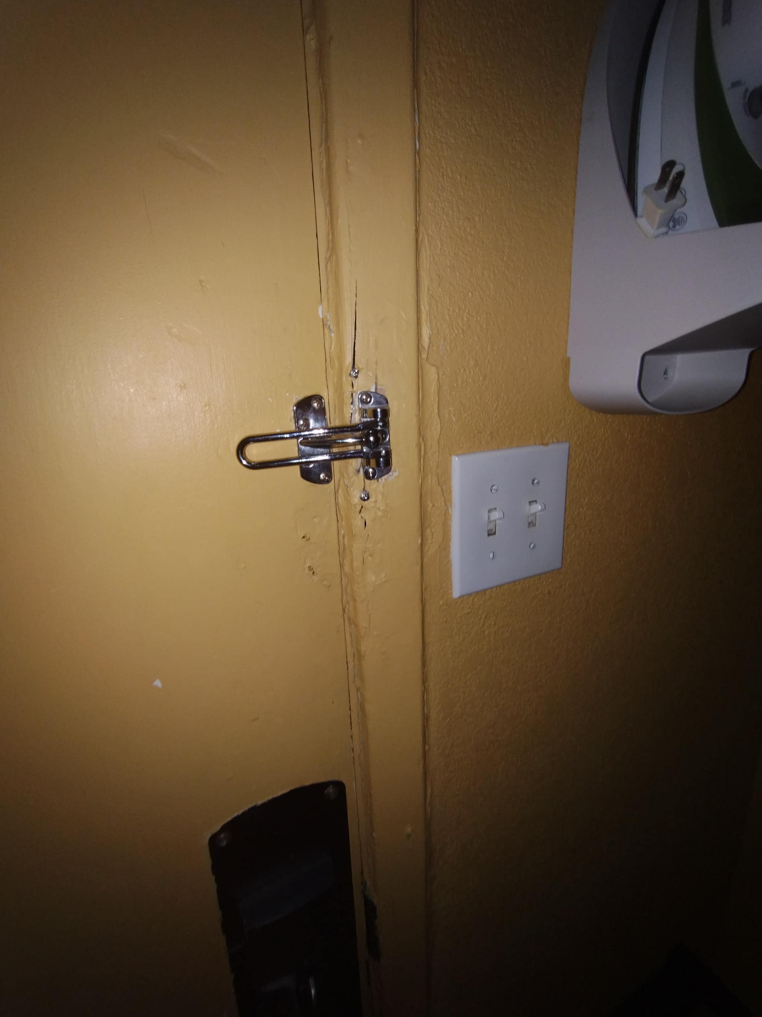 The prior lock was replaced and the new lock is not secure due to the splitting of the wood.