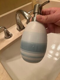 What looked like design turned out to be old soap that was stuck onto the dispenser