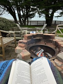 Sitting on their deck with fire over looking beach