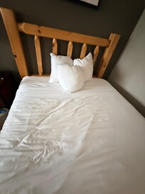 Small pillows in standard pillow cases rolled up. This is what we walked into. Hairs all over sheets and visible drool stained pillowcases.