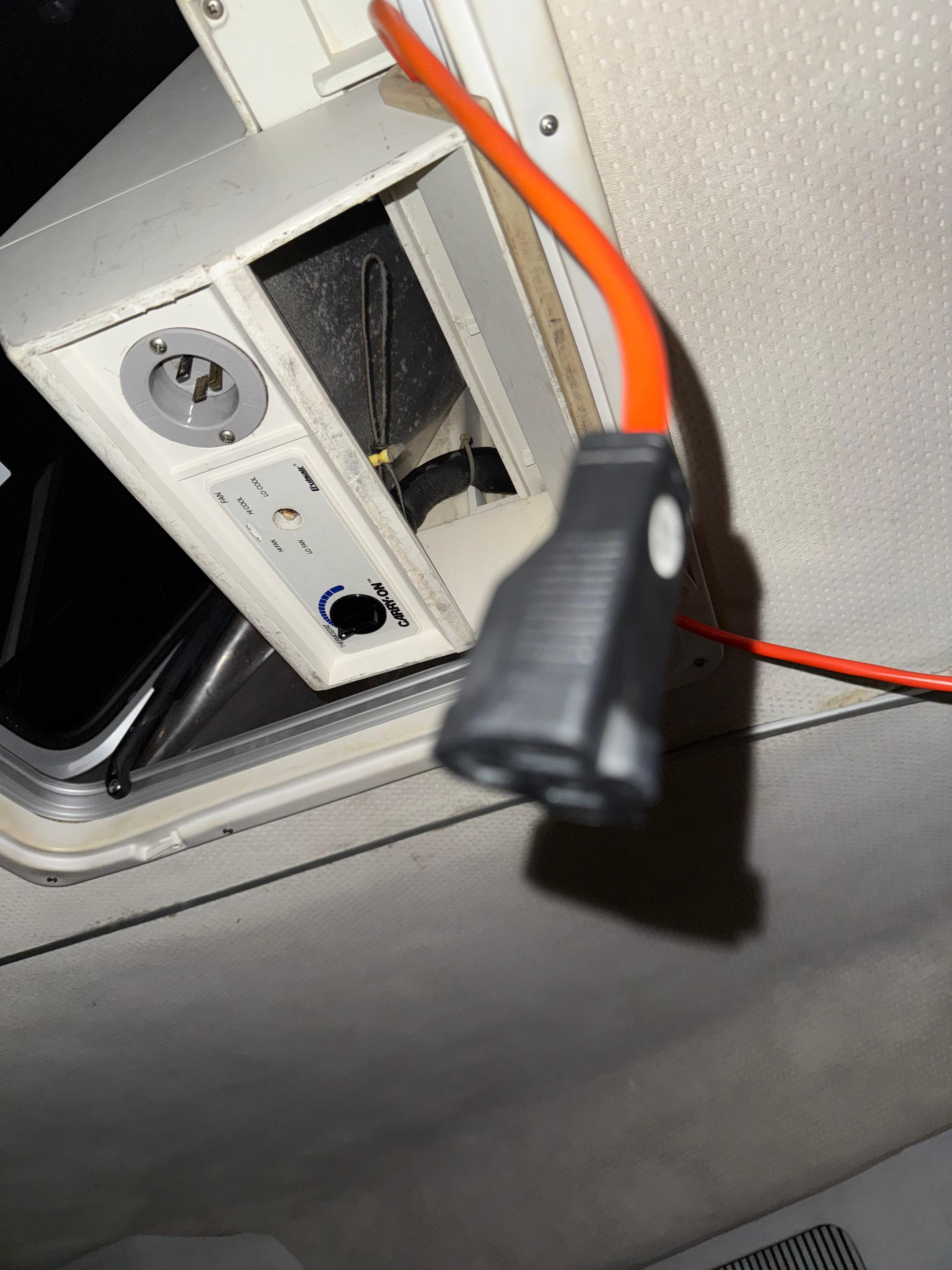 Extension cord hanging from the ceiling of the master bedroom for no parent reason. 