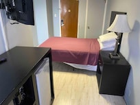 Tiny room with threadbare bedspread