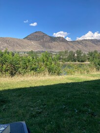 Photo taken from back of hotel in grassy sitting area.