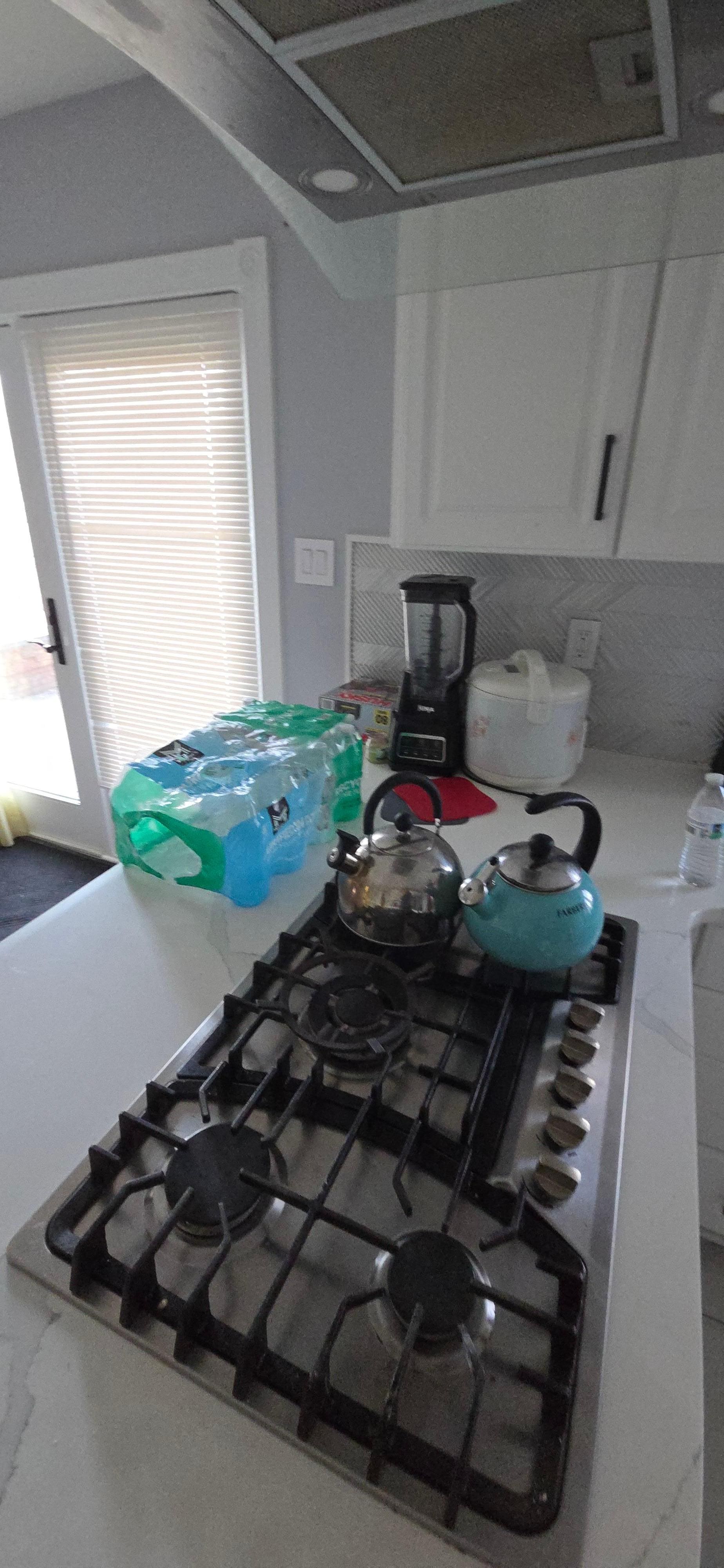 Random stuff left on counter and stove top 