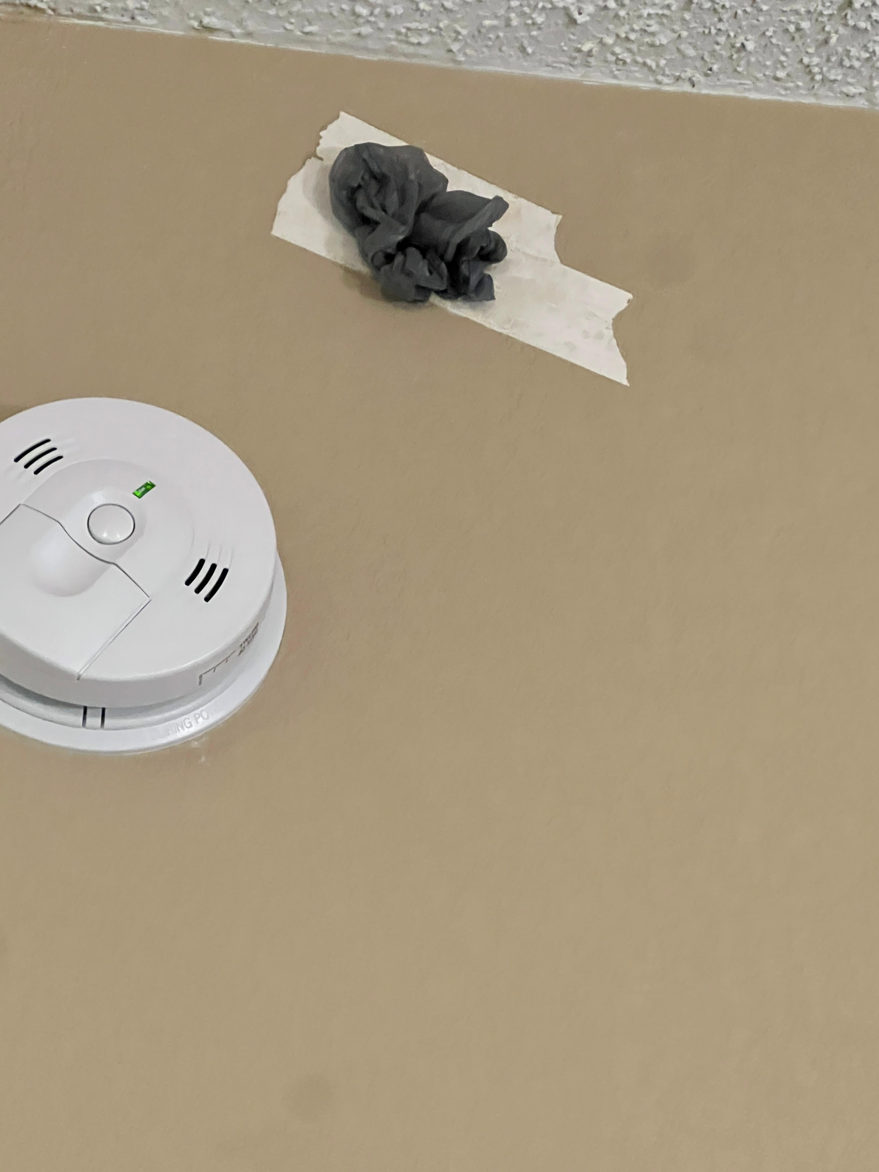 Hole in wall stuffed with a plastic grocery bag,