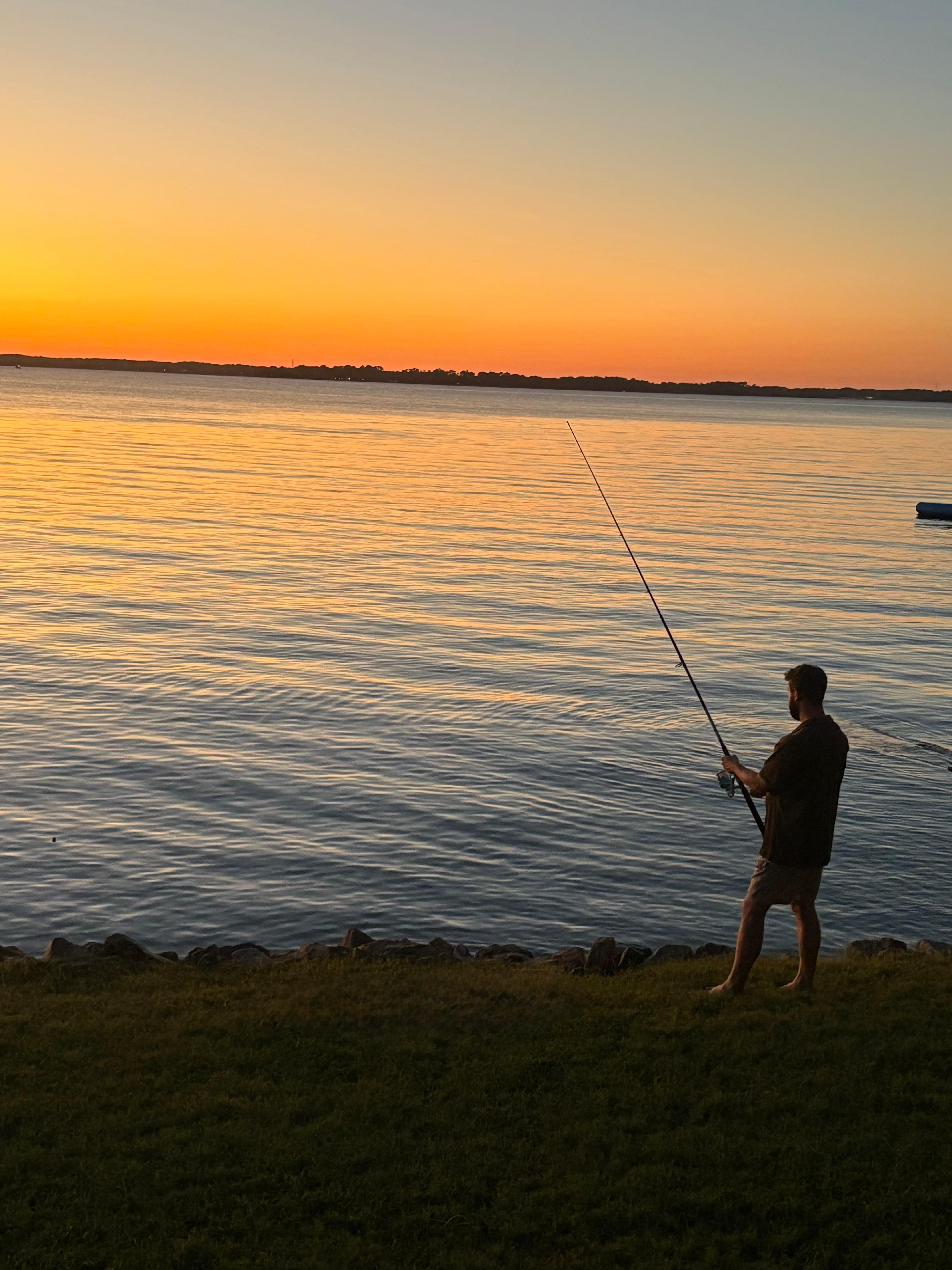 Fishing off the rocks at sunset. 