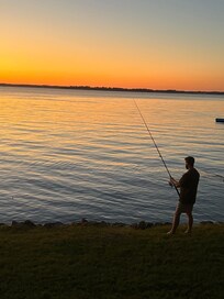 Fishing off the rocks at sunset.