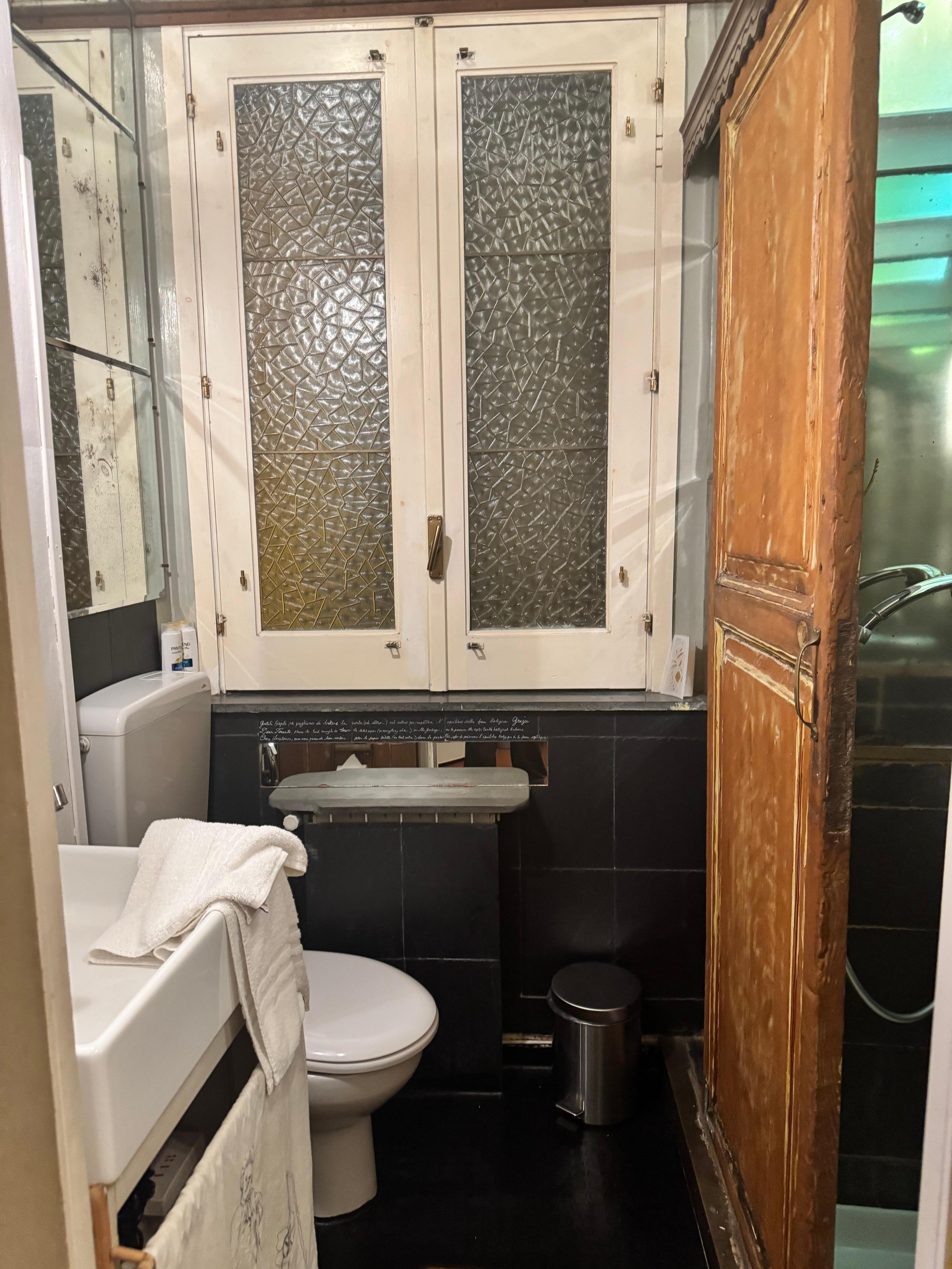 Bathroom, shower wood sliding door on right