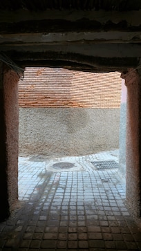 A bit further along, you have to take this passageway through a building on your left.