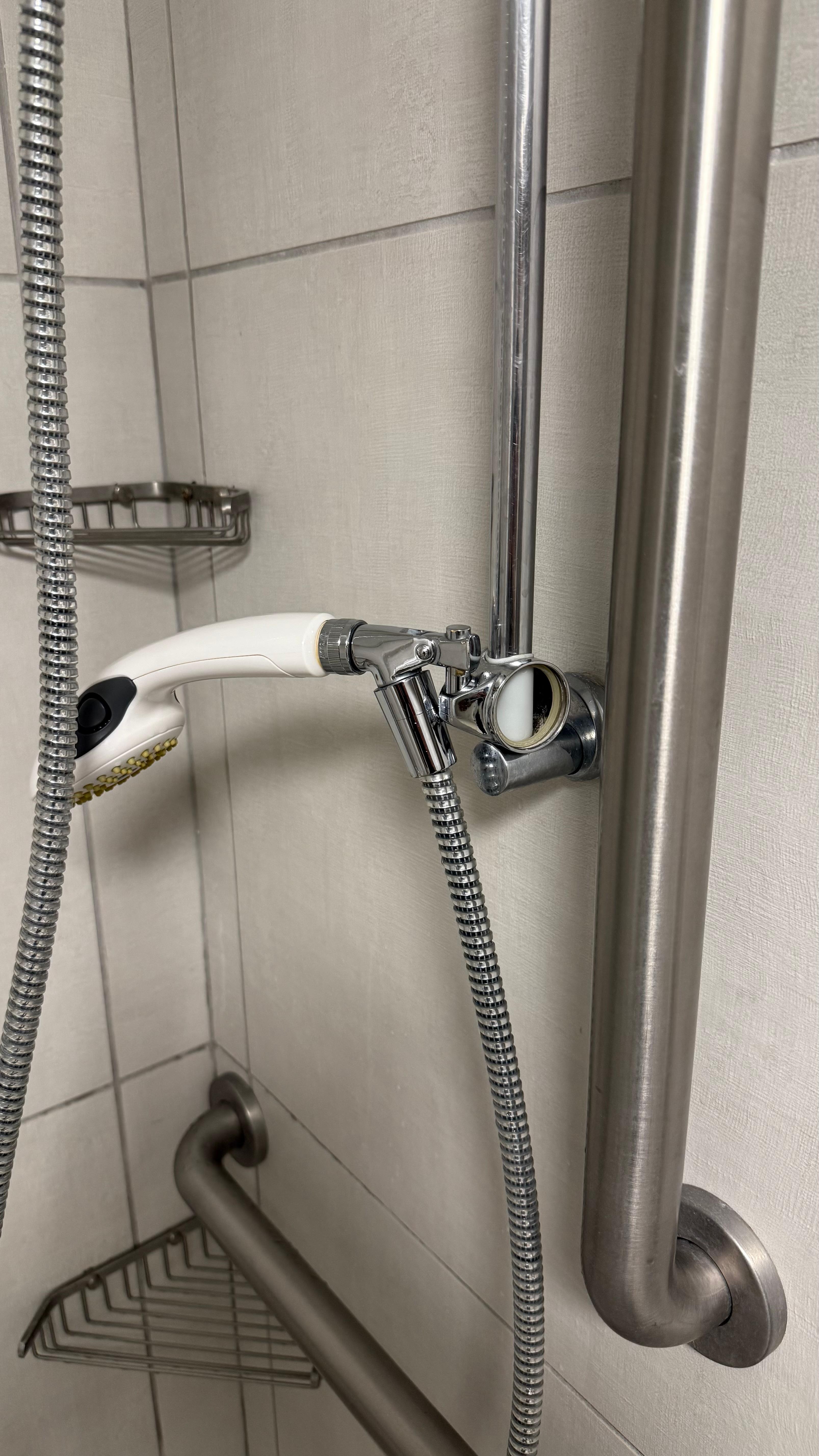 Broken shower height adjuster button.