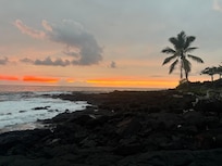 Black rocks beside the condo.