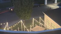Outdoor lounge area with lights…