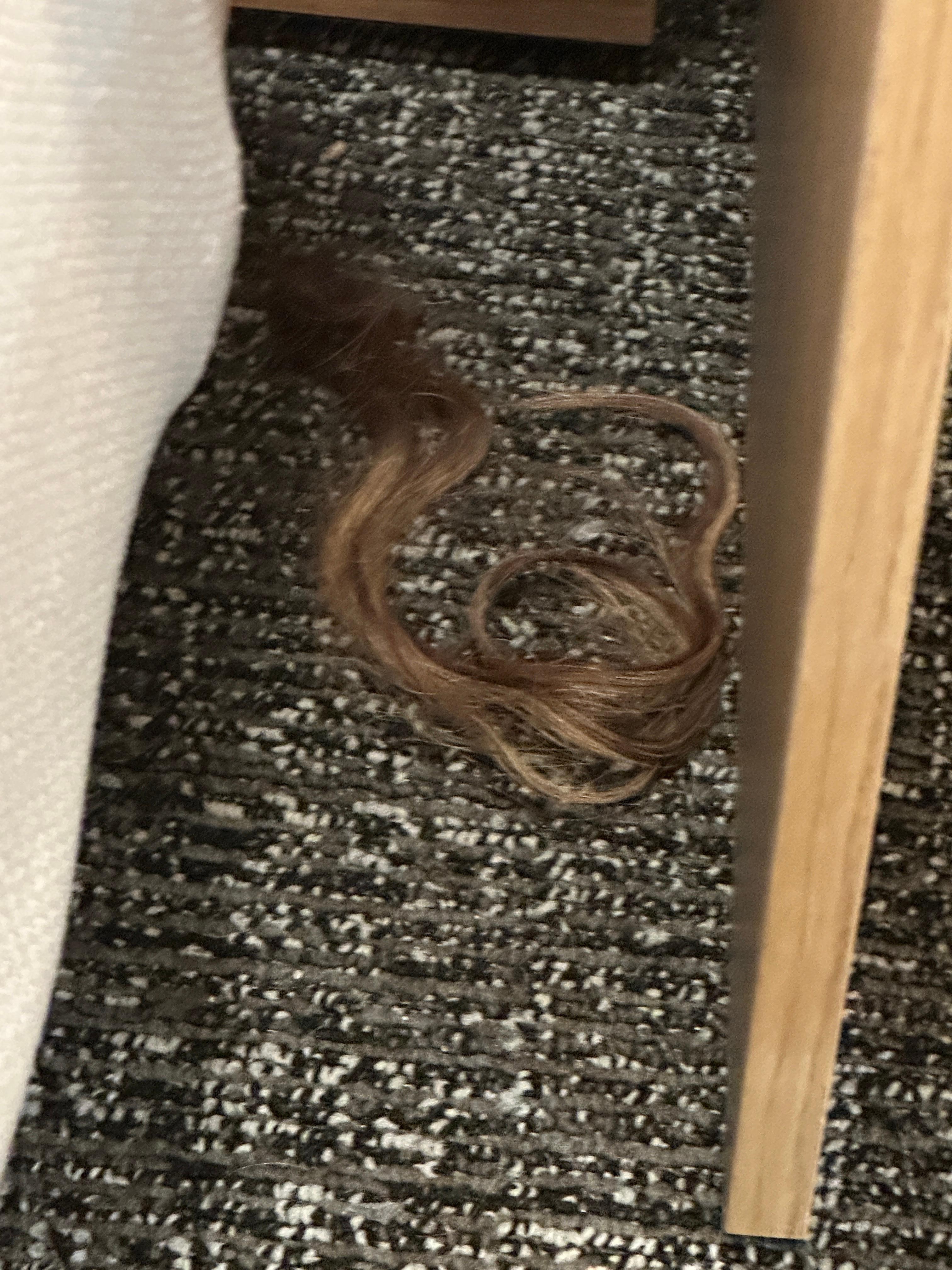 Hair piece between bed and bedside table 
