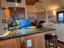 Looking towards kitchen and fireplace