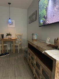 Living area w/couch, chair tv, cozy dinette