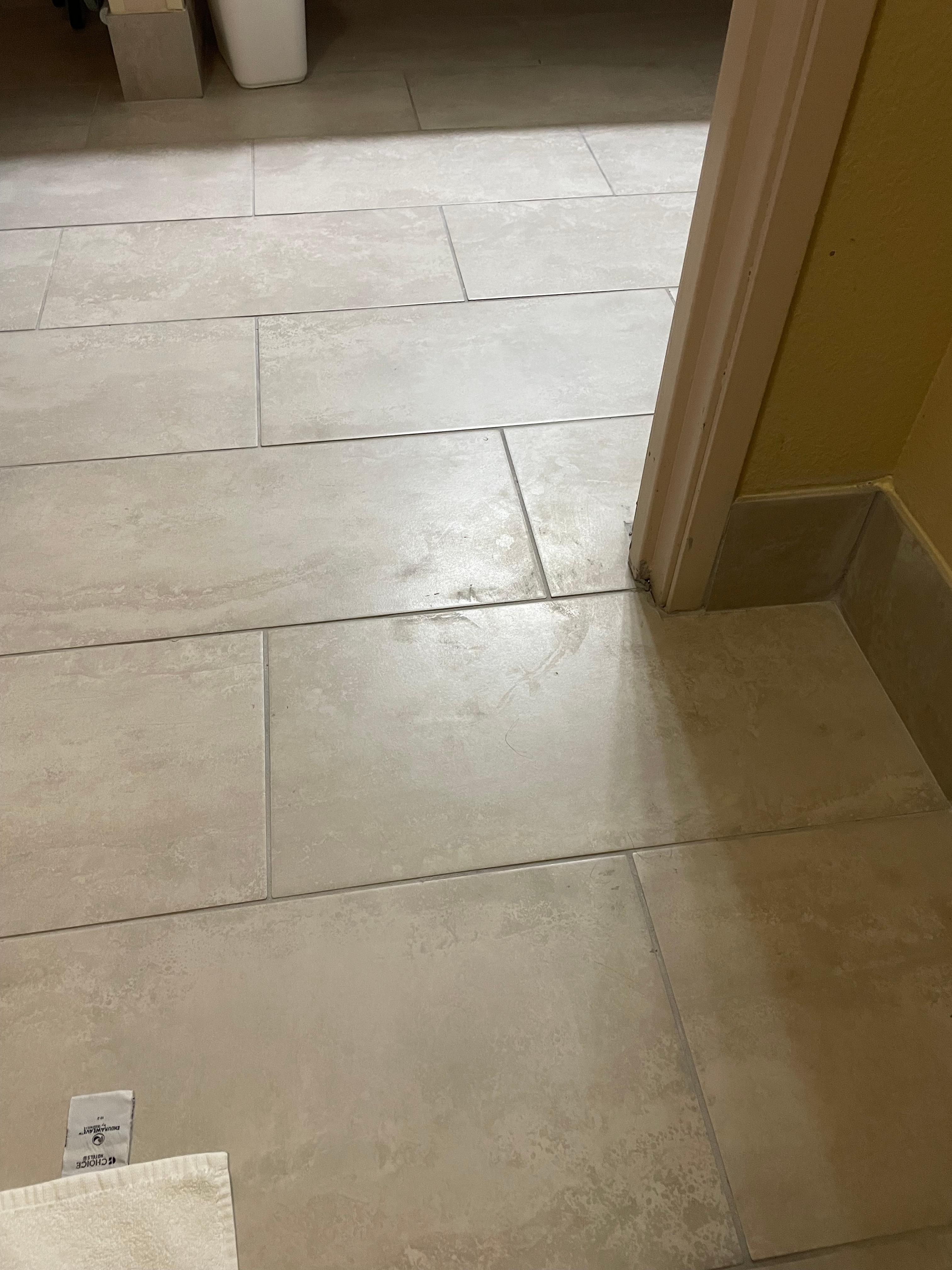 Tile floor between the bathroom and entryway