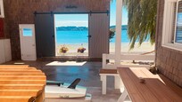 Awesome covered porch with hot tub, bench and room to store our paddle boards.